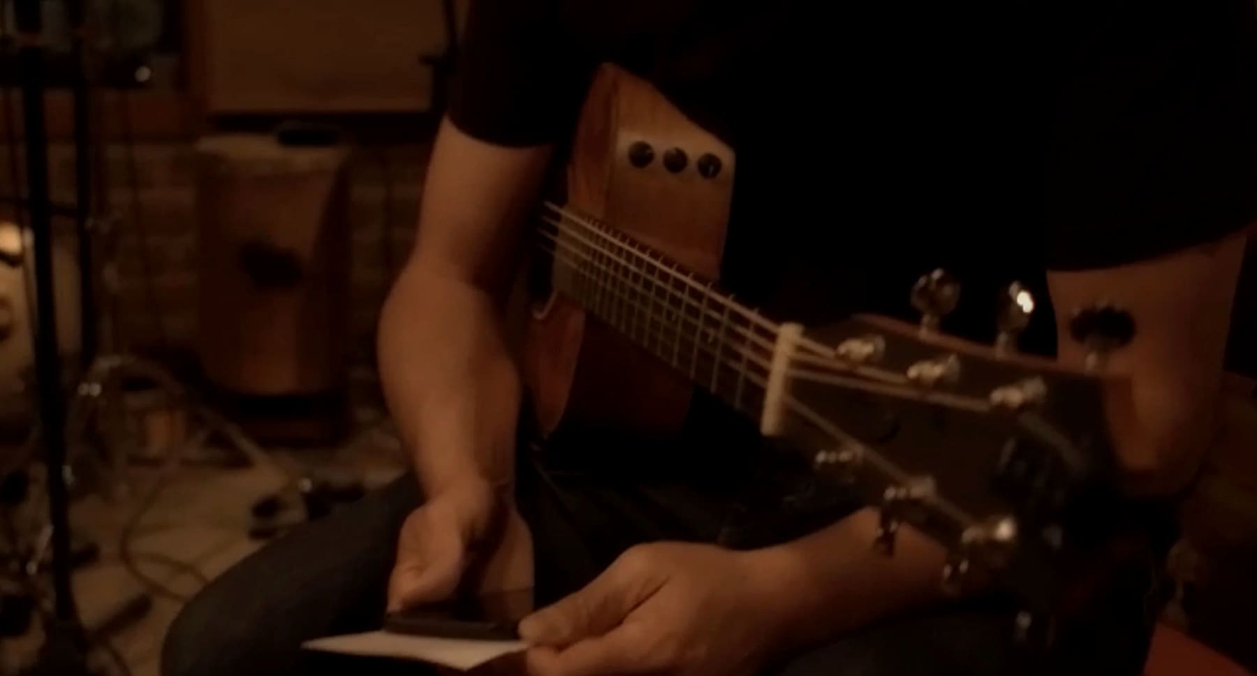 Hands on the guitar between takes